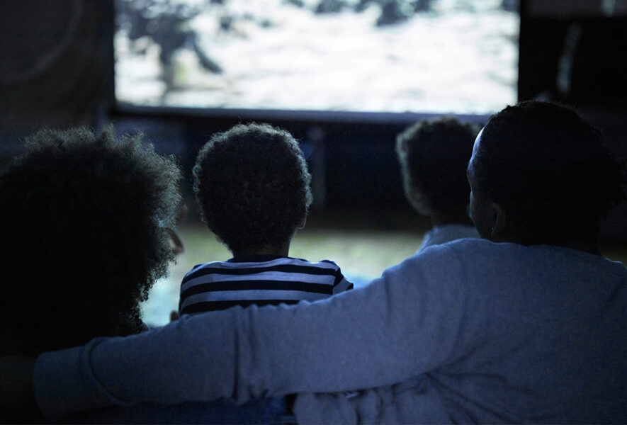 Family watching tv together